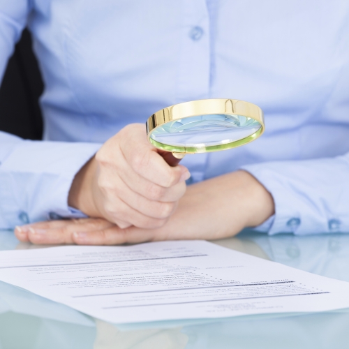 Businesswoman Holding Magnifying Glass